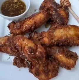 Delicious hot honey chicken tenders served on a plate for two