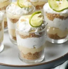 Delectable Key Lime Pie Parfaits served in clear glasses with lime garnish