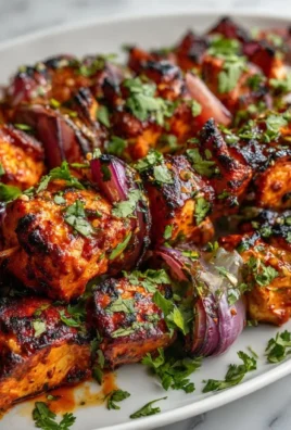 Spicy Mexican barbecue chicken skewers grilled with vibrant vegetables.