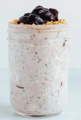 Delicious overnight oats served in a bowl with fresh fruits and nuts.