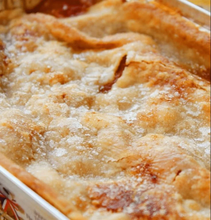 Delicious Patti Labelle's Peach Cobbler served in a rustic dish