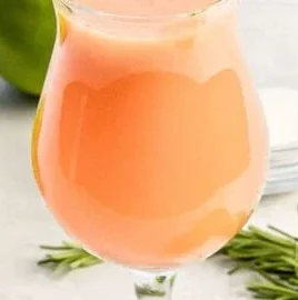 A refreshing glass of Peach Fresh Water with sliced peaches and mint leaves.