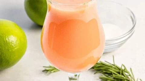 A refreshing glass of Peach Fresh Water with sliced peaches and mint leaves.