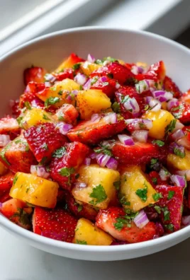 Bowl of refreshing strawberry pineapple mango salsa with colorful fruits