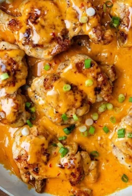 Skillet Bang Bang Chicken Thighs served on a plate with fresh herbs