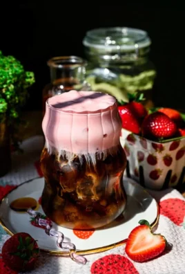 A creamy cup of strawberry cold foam topping on a refreshing drink.