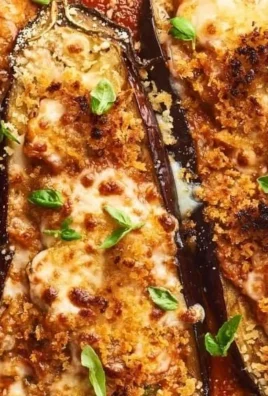 Stuffed Eggplant Parmesan topped with cheese and herbs in a baking dish