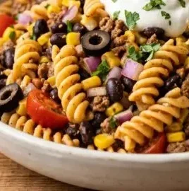 Colorful Taco Pasta Salad with beans, cheese, and fresh vegetables in a bowl