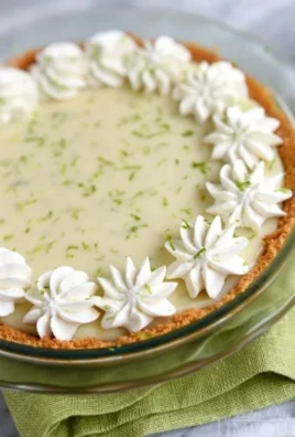 A slice of delicious key lime pie with a creamy filling and graham cracker crust.