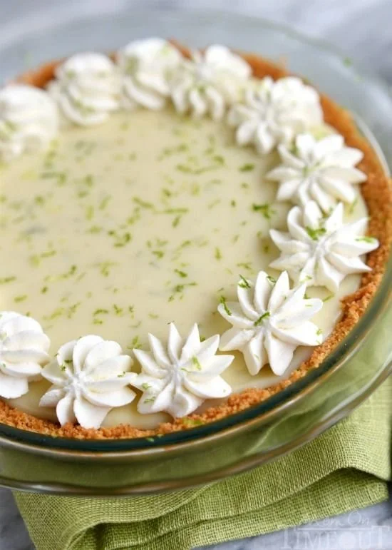 A slice of delicious key lime pie with a creamy filling and graham cracker crust.