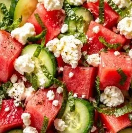 Refreshing watermelon feta cucumber salad served on a plate with mint leaves