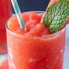 Refreshing homemade watermelon drink in a glass with mint leaves.