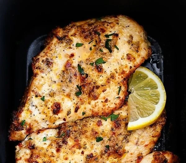 Air Fryer Garlic Parmesan Chicken served with herbs and spices