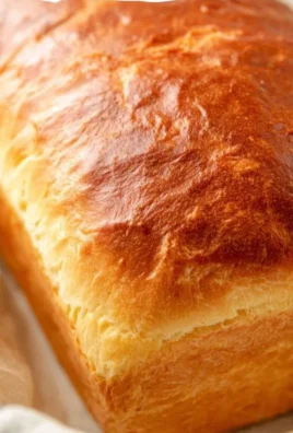 Loaf of Amish Sweet Bread on a wooden table with ingredients