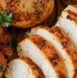 Baked boneless skinless chicken breasts served with vegetables