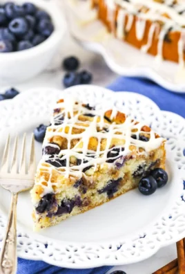 Slice of Blueberry Streusel Coffee Cake topped with blueberry and streusel