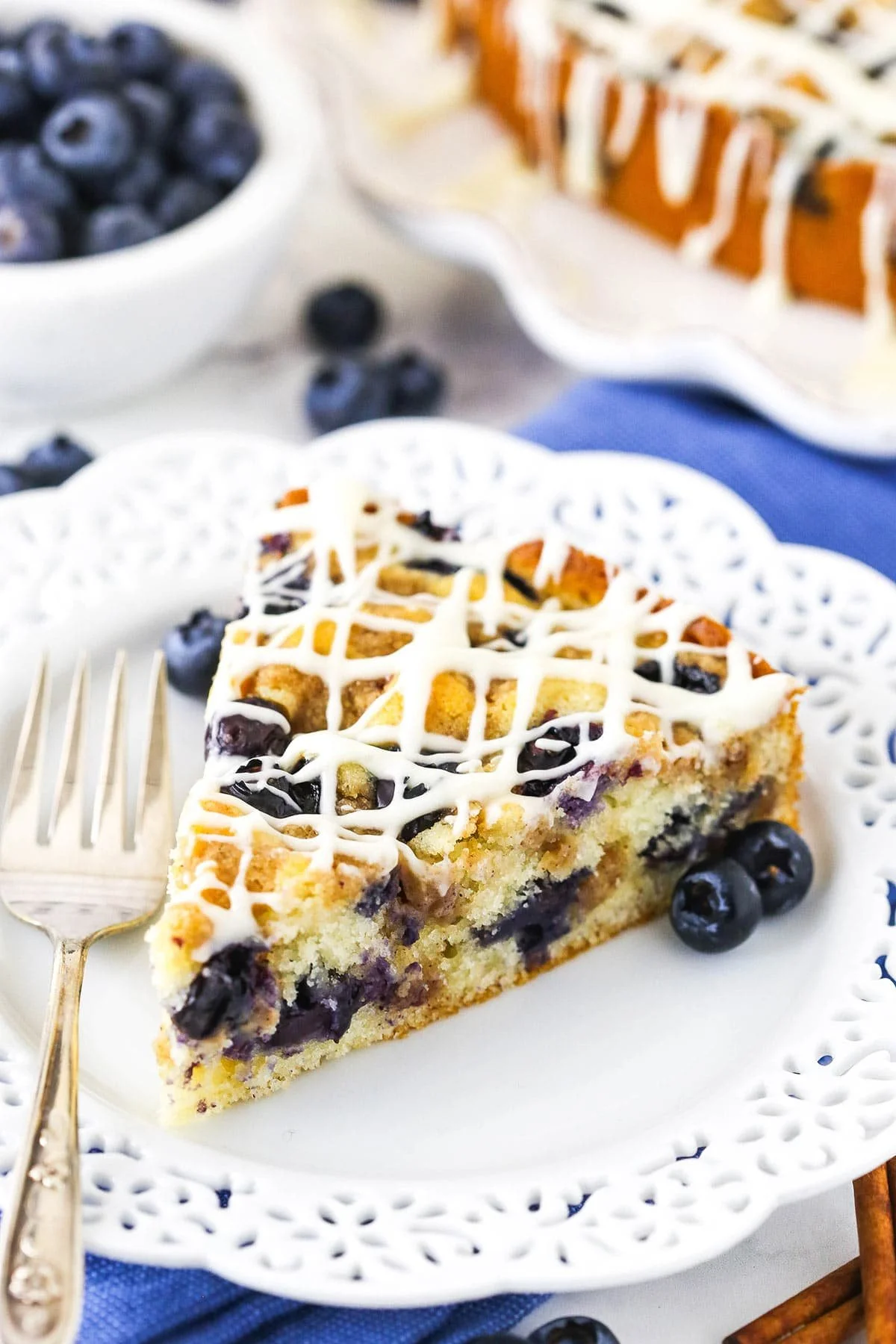 Slice of Blueberry Streusel Coffee Cake topped with blueberry and streusel