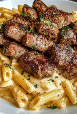 Cajun Steak Tips with penne pasta in creamy Parmesan cheese sauce