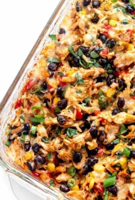 A delicious Chicken Burrito Casserole served in a dish, topped with cheese and fresh ingredients.