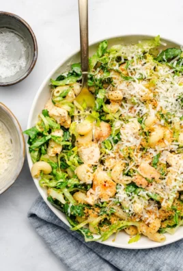 Delicious Chicken Caesar Pasta Salad in a bowl with fresh toppings.