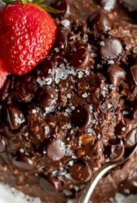 Bowl of chocolate baked protein oats topped with nuts and berries