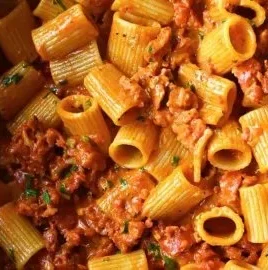 Delicious creamy chorizo pasta topped with herbs in a bowl