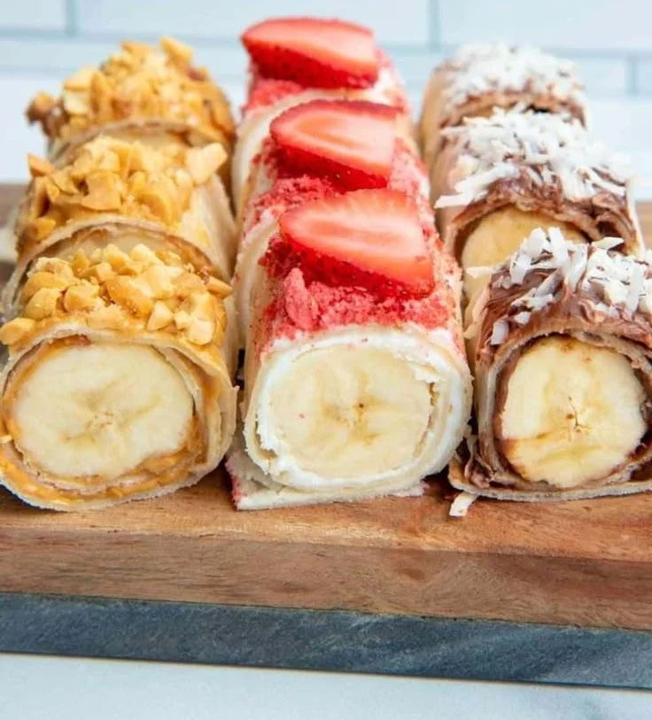 Easy banana sushi rolls with chocolate and nuts on a plate