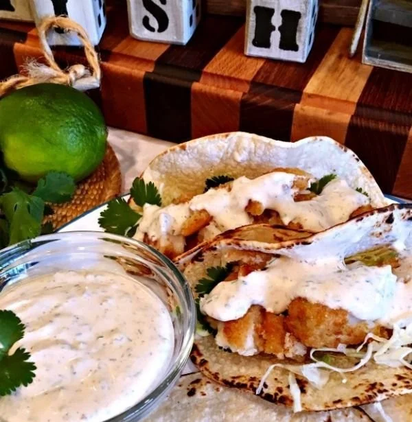 Delicious easy fish tacos garnished with fresh vegetables and lime