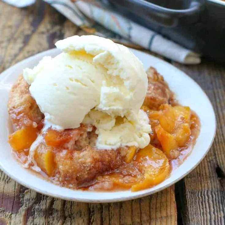 Delicious homemade peach cobbler with fresh peaches in a baking dish