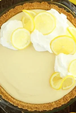 Slice of easy lemon cream pie topped with whipped cream and lemon zest
