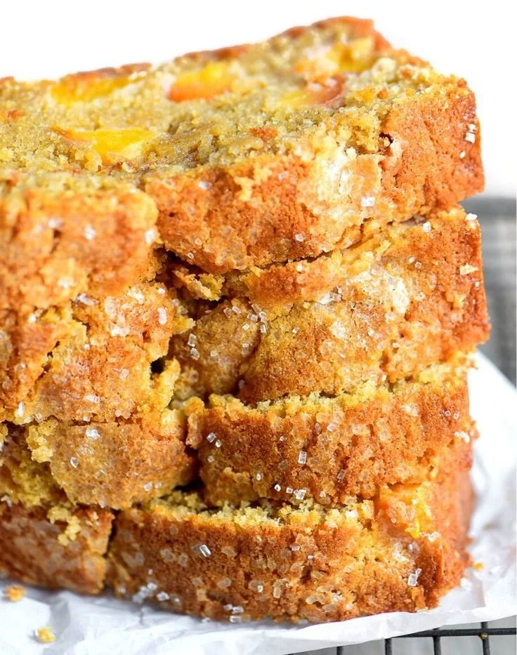Slice of easy spiced peach bread garnished with fresh peach slices