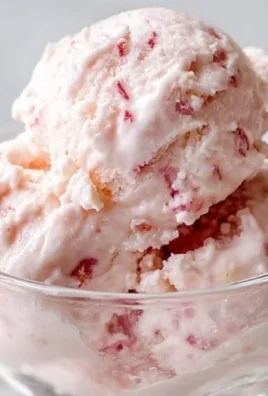 Easy strawberry cottage cheese ice cream in a bowl topped with fresh strawberries