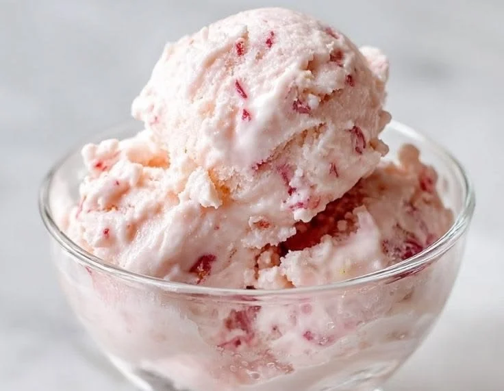 Easy strawberry cottage cheese ice cream in a bowl topped with fresh strawberries