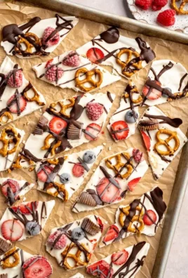 Delicious frozen yogurt bark topped with fruit and nuts.