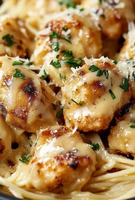 Delicious garlic butter chicken bites served with creamy parmesan pasta.