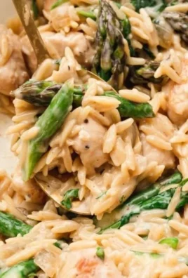 High protein chicken orzo dish with fresh vegetables and herbs