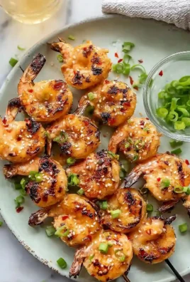 Juicy Grilled Bang Bang Shrimp Skewers garnished and ready to serve.
