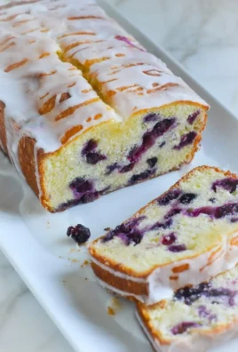 Delicious Lemon Blueberry Pound Cake decorated with fresh berries