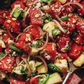 Vegan minty watermelon cucumber salad in a bowl with fresh mint leaves