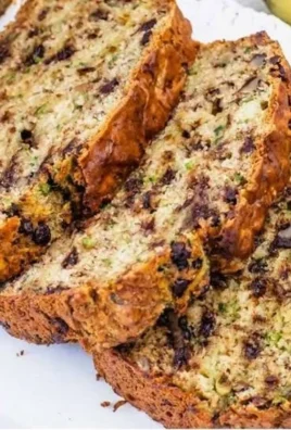 Moist and delicious banana zucchini bread sliced on a wooden board