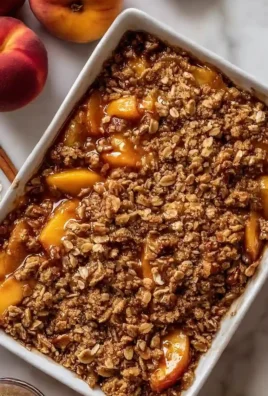 Delicious Pecan Bourbon Peach Crisp dessert served in a rustic dish with a golden topping.