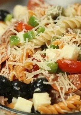 Bowl of colorful quick and easy Italian Pasta Salad with fresh vegetables and dressing.