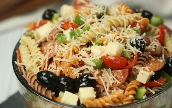 Bowl of colorful quick and easy Italian Pasta Salad with fresh vegetables and dressing.