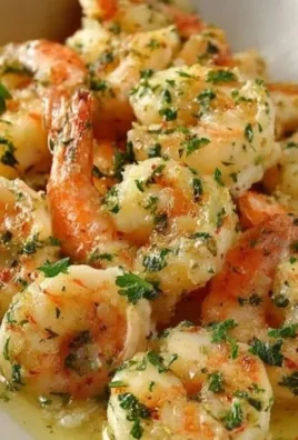 Shrimp Scampi Pasta Bake topped with herbs and cheese, served in a baking dish.