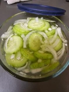 Simple cucumber and onion salad served in a bowl with fresh herbs
