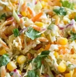 Bowl of spicy corn slaw with fresh vegetables for a summer dish