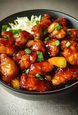 Sweet Hawaiian Chicken cooked in a Crock-Pot, decorated with pineapple and herbs