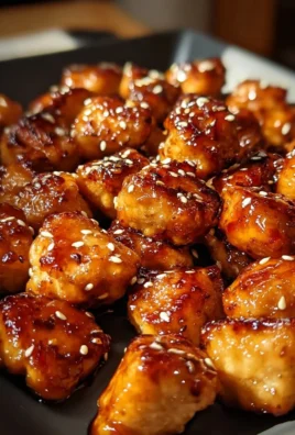 Sweet and smoky honey garlic chicken bites served on a platter.