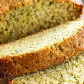 Loaf of freshly baked zucchini bread on a wooden table