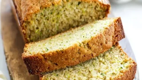 Loaf of freshly baked zucchini bread on a wooden table